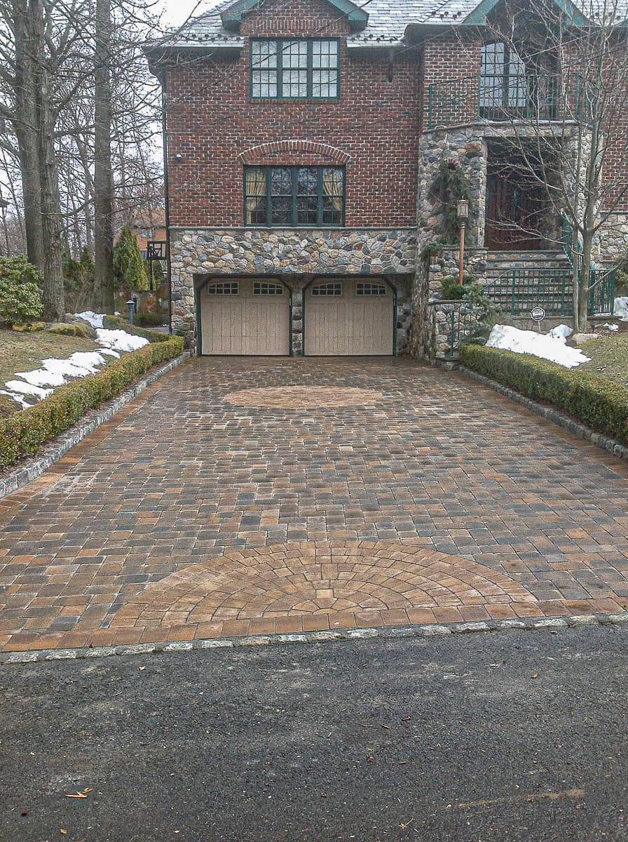 Multi-colored driveway with designs.